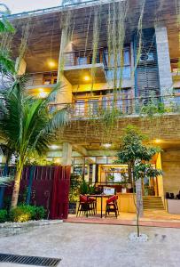 a building with a table and chairs in front of it at Privee Dhaka - PRIVEE RESORT & RESTAURANT in Bholānāthpur