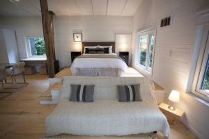 a bedroom with two beds and two windows at Mareas Ralun Lodge in Ralún