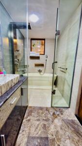 a bathroom with a glass shower and a sink at Privee Dhaka - PRIVEE RESORT & RESTAURANT in Bholānāthpur +130 photos