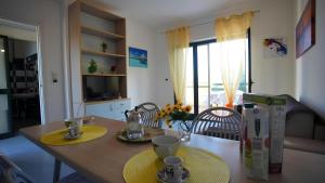 a dining room table with two cups on top of it at Charme by the Sea, Sant'Andrea in SantʼAndrea Apostolo dello Ionio