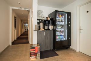 a refrigerator filled with drinks in a hallway at Book Hotel Leipzig in Leipzig
