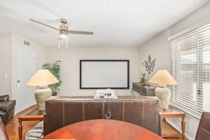 a living room with two lamps and a tv at Naturally Modest & Quiet in Sun City West