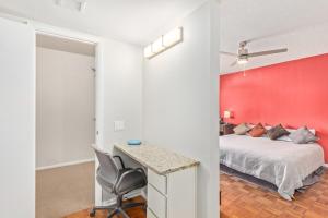 a bedroom with a bed and a red wall at Naturally Modest & Quiet in Sun City West