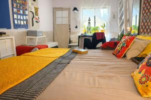 a large bed with a yellow blanket on top of it at Sun Bloom in Mumbai