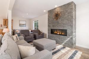 a living room with a couch and a fireplace at Recharge by The River by NW Comfy Cabins in Leavenworth