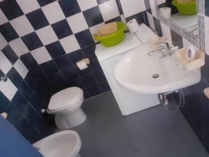 a bathroom with a toilet and a sink at Charme by the Sea, Sant'Andrea in SantʼAndrea Apostolo dello Ionio +23 photos
