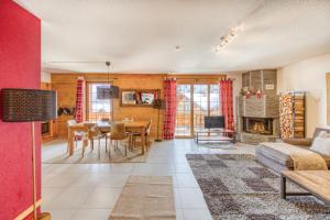 a living room with a table and a fireplace at Ski-in Ski-out with Chimney and view in Les Crosets