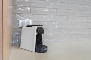 a kitchen appliance sitting on a counter next to a wall at Relax at Trinity in Trinity Beach +27 photos