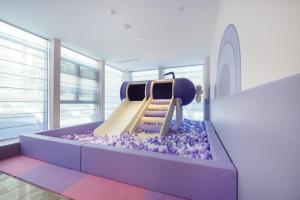 a childrens play area with a slide in a room at Mercure Luoyang Downtown in Luoyang +95 photos