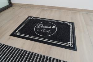 a black rug on a wooden floor in a room at Cityhotel Donauwörth in Donauwörth
