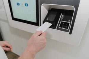 a person holding a piece of paper in an atm at Cityhotel Donauwörth in Donauwörth