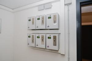a row of white switches on a wall at Cityhotel Donauwörth in Donauwörth +40 photos