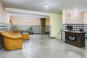 a restaurant with tables and chairs in a room at Hotel O Dwarka Metro in New Delhi