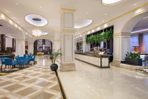 a lobby with a restaurant with blue chairs and a bar at Juju Premier Palace Hotel-Ultra All Inclusive in Beldibi +141 photos