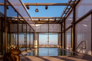 an indoor pool in a building with glass walls at Clarion Hotel Helsinki in Helsinki