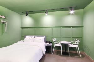 a bedroom with two beds and a table and chairs at Novahotel in Samgong
