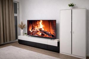 a fireplace in a living room with a fire in it at City Rooms Koblenz Hbf in Koblenz