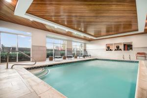 a swimming pool in a building with a ceiling at Hampton Inn Rutland/Killington in Rutland