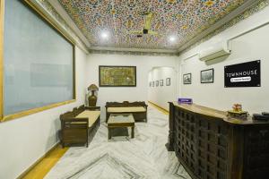 a waiting room with chairs and a chalkboard on the wall at Townhouse Chandpole Metro Station Formerly Hotel Raghuraj Palace in Jaipur