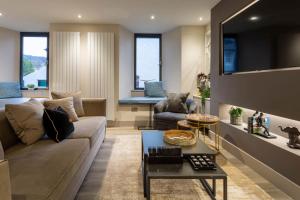 a living room with a couch and a table at Arran Shores Luxury Shorefront Apartment 3 in Lamlash