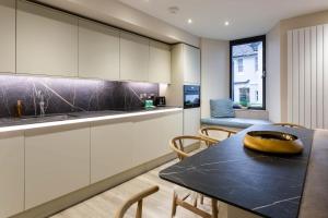 a kitchen with a table with a banana on it at Arran Shores Luxury Shorefront Apartment 3 in Lamlash