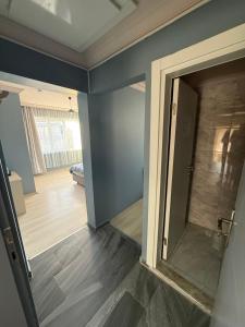 a room with blue walls and a door with a wooden floor at Flora Otel 16 rooms in Edirne +34 photos