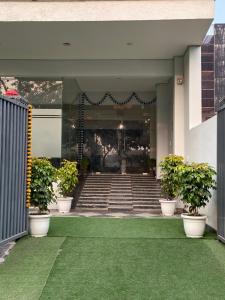 a stairway with potted plants on a building at Hotel Stayzzy Bloom in Noida