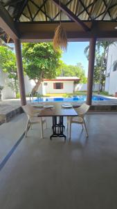a table and chairs on a patio with a view at The Reef Edge in Matara