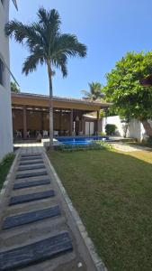 a house with a palm tree in front of it at The Reef Edge in Matara