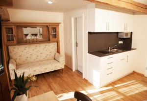 a living room with a couch and a sink at Pension Kranzmayr in Sankt Wolfgang