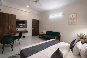 a bedroom with a bed and a living room at Hotel Stayzzy Bloom in Noida