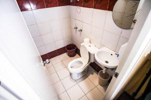 a small bathroom with a toilet and a sink at Astrotel Novaliches in Manila +18 photos