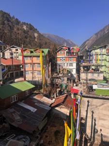 a group of buildings in a city with mountains at Juniper Mountain Resort in Lachen