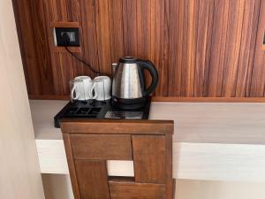 a coffee pot sitting on top of a table at Juniper Mountain Resort in Lachen +10 photos