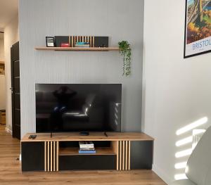 a living room with a flat screen tv on a wall at Apartament Bristol in Mielec