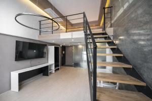 a staircase in a house with a flat screen tv at Connected Hotel Guro in Seoul
