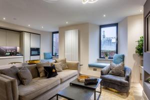a living room with a couch and two chairs at Arran Shores Luxury Shorefront Apartment 4 in Lamlash