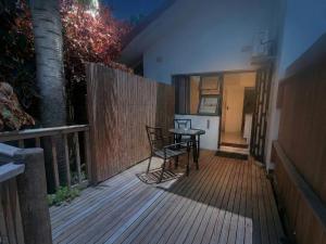 a wooden deck with a table and chairs on it at Rembrandt - Zur See in Ballito