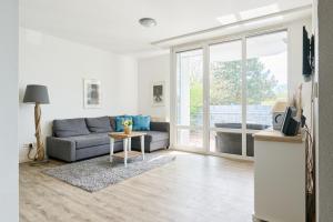 a living room with a couch and a table at Ferienwohnung Bootsteg Moba-Travel in Priwall