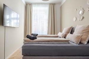 a room with a couch with two lenses on it at Boho Living Altstadt Suites - Free Parking by HERO HOMES Graz in Graz