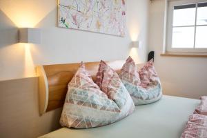 a group of pillows sitting on top of a bed at Apartment Wenger Leogang in Leogang