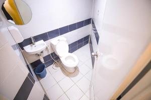 a small bathroom with a toilet and a sink at Astrotel Novaliches in Manila