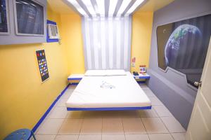 a hospital room with a bed in a room with a window at Astrotel Novaliches in Manila