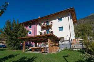 a building with a balcony on the side of it at Agriturismo Gli Elfi in Aosta