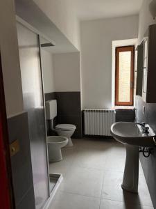 a bathroom with two toilets and a sink at Residenza Il Castello Tre in CastellʼArquato +25 photos