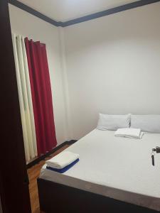 a bedroom with a bed with two towels on it at Bayakyak Soie Residence in General Luna