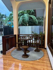 a porch with a table and two stools at Bayakyak Soie Residence in General Luna +9 photos