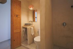 a bathroom with a toilet and a sink and a shower at Blue Waves Surf House - Anza I in Agadir +34 photos