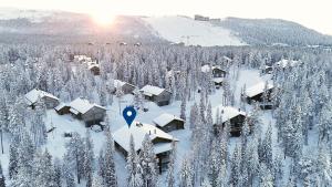 an aerial view of a resort with snow covered trees at Villa Taruilevi 3 inc Hot Tub in Levi