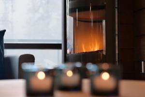 a chandelier with a fire in a window at Villa Taruilevi 3 inc Hot Tub in Levi